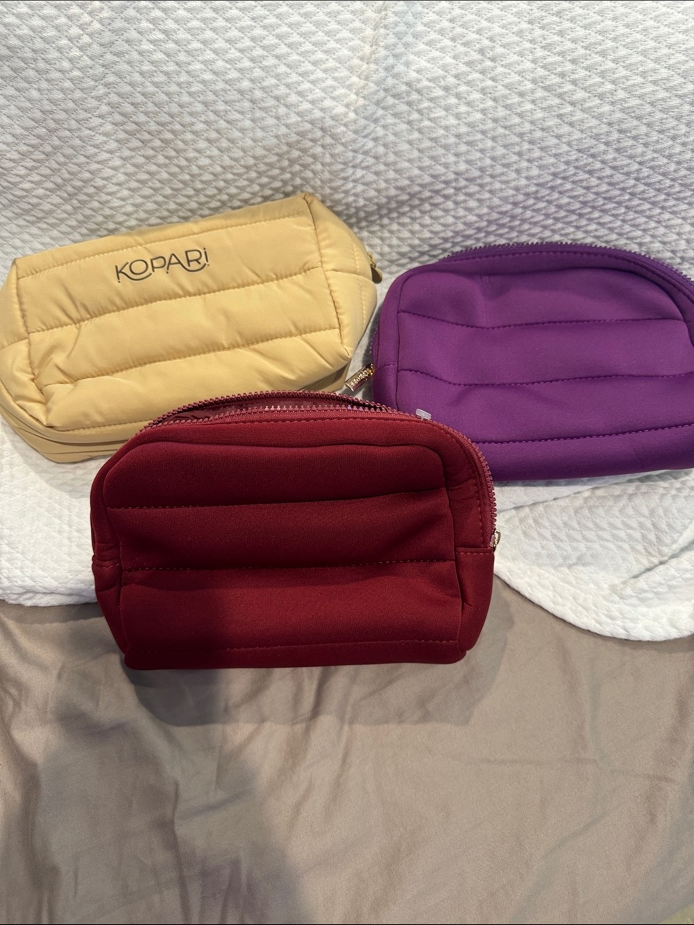 Kopari Quilted Cosmetic Pouch Trio in Red, Purple & Yellow